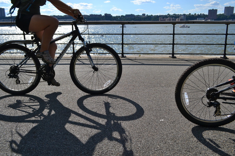 activity, bike riding, cyclist, female, riverside drive, riding, land vehicle, wheel, recreation, sport, transportation, travel, sunny, lifestyle, people