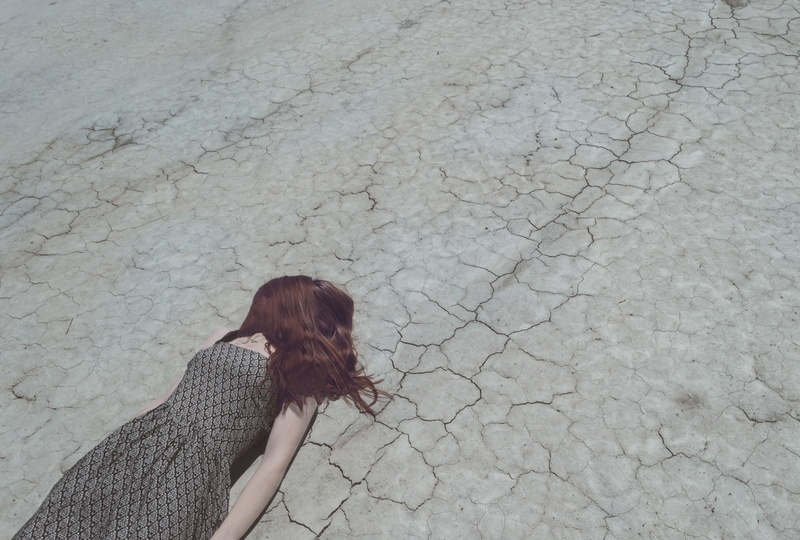 lying, high angle view, people, outdoors, arid climate, dress, women, summer, drought, depression, land, hairstyle, day, beach, dry, adult, hair, nature