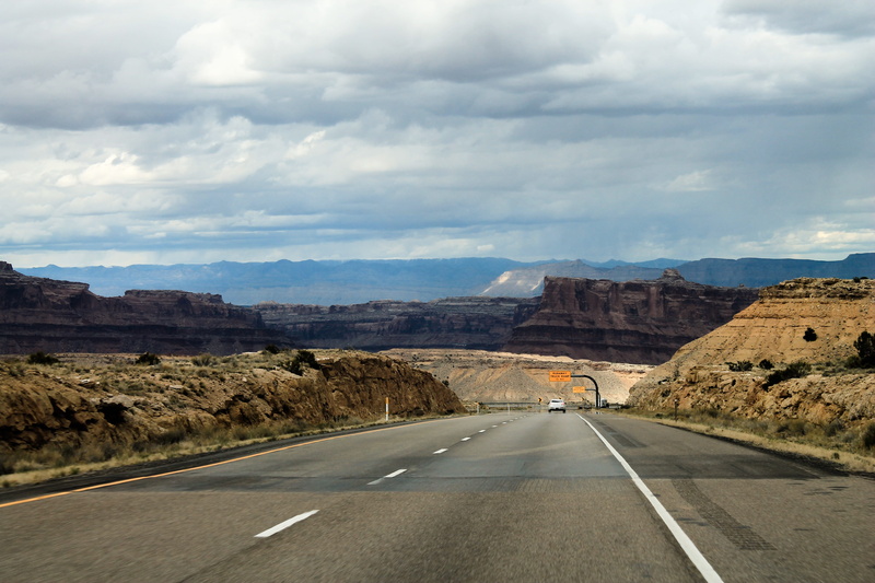 solid, diminishing perspective, direction, travel, geological, sign, western, rock - object, red, orange, non-urban scene, eroded, southwest, road, natural