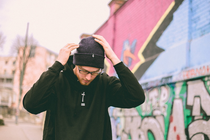 hooded, 4K, waist up, portrait, adult, city, cross, jacket, warm clothing, clothing, hip hop, touching, street art, knit, front view, glasses, man, one person