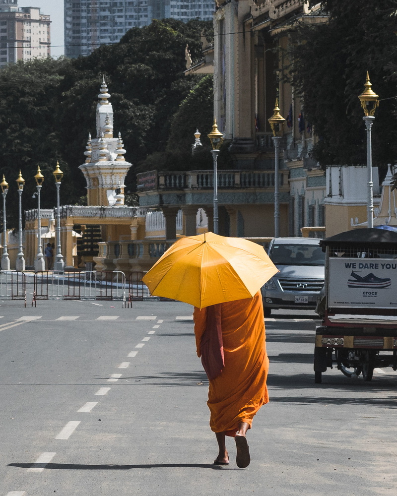 phnom penh, real people, religion, transportation, lifestyles, one person, mode of transportation, day, building exterior, buddhist, architecture, full length