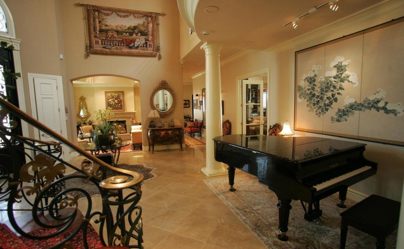 table, luxury, built structure, lighting equipment, grand piano, building, seat, domestic room, home, illuminated, staircase, wealth, indoors, no people