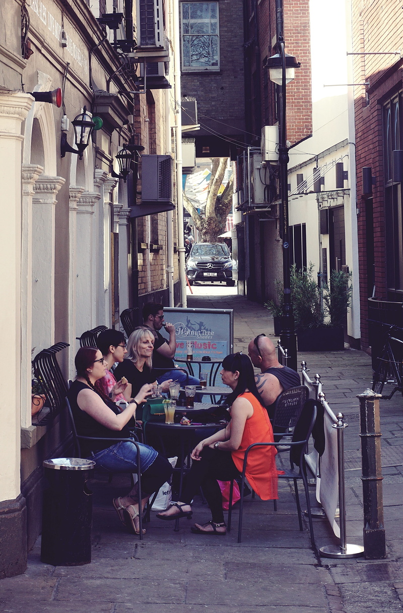 group, outdoors, tourist, women, 4K, city, road, table, building, group of people, lifestyles, daylight, pavement, men, chairs, street, people, commerce