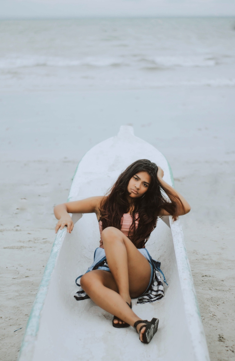 tone, coat, woman, pseudo, hair, legs, color, one person, sitting, leisure activity, waves, looking at camera, composition, full length, 4K, water, lifestyles