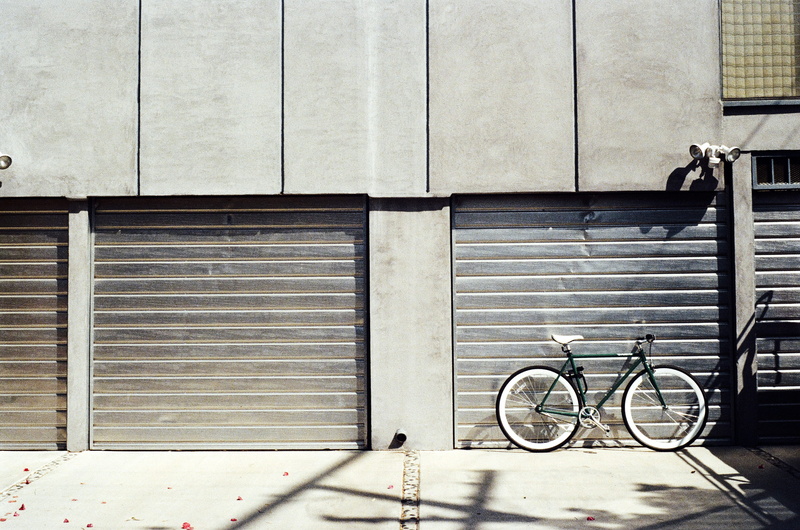 land vehicle, 2K, door, footpath, city, architecture, parking, wheel, bike, building, window, built structure, wall, safety, outdoors, day, shutter, building exterior