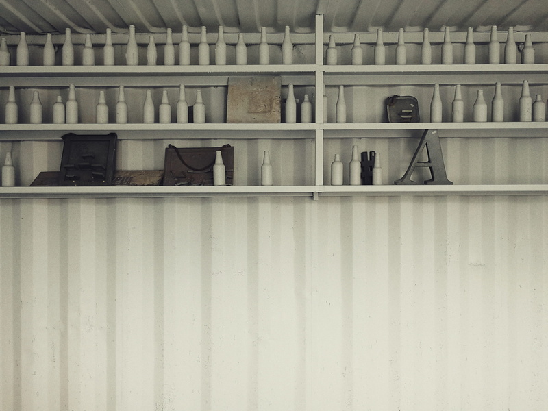 in a row, table, room, cabinet, white, domestic room, indoors, order, architecture, reception, no people, concrete, absence, shelf, closet, container, built structure