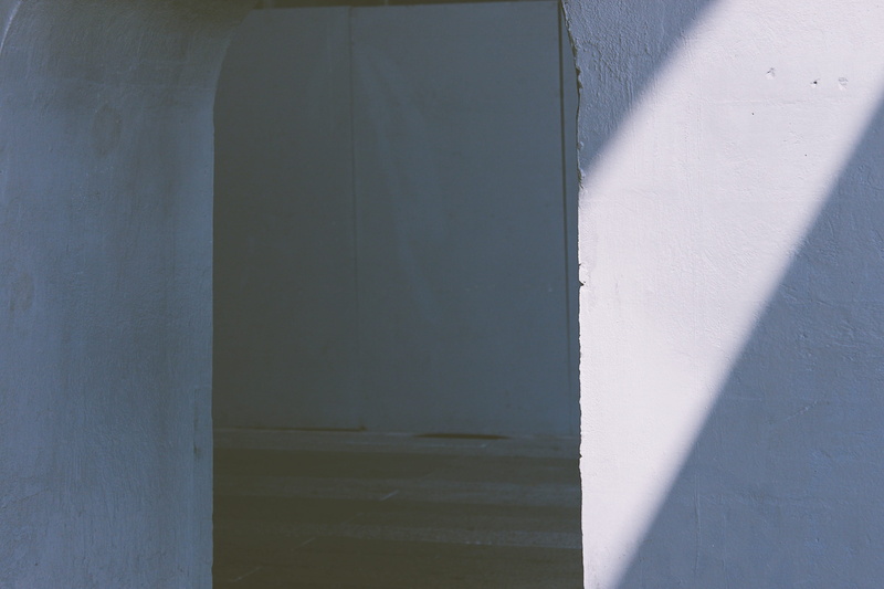 indoors, shadow, window, apparel, pants, outdoors, building exterior, cupboard, wall - building feature, wall, crypt, furniture, clothing, door, 2K, day