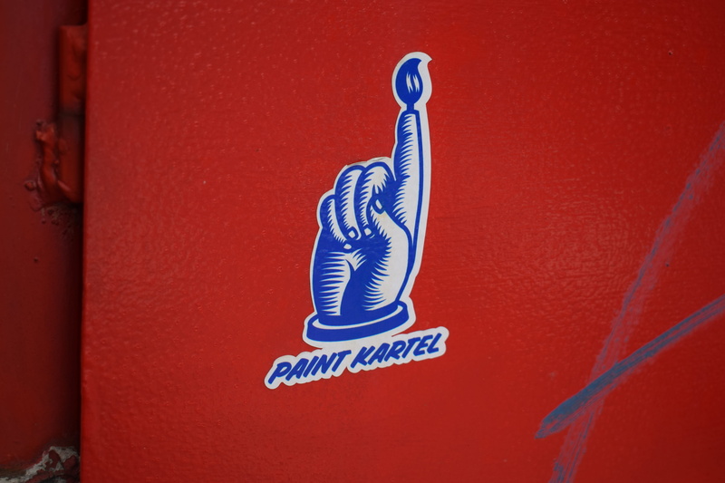 wall - building feature, representation, emblem, swimwear, cap, animal, western script, logo, red, text, close-up, apparel, painting, day, male likeness
