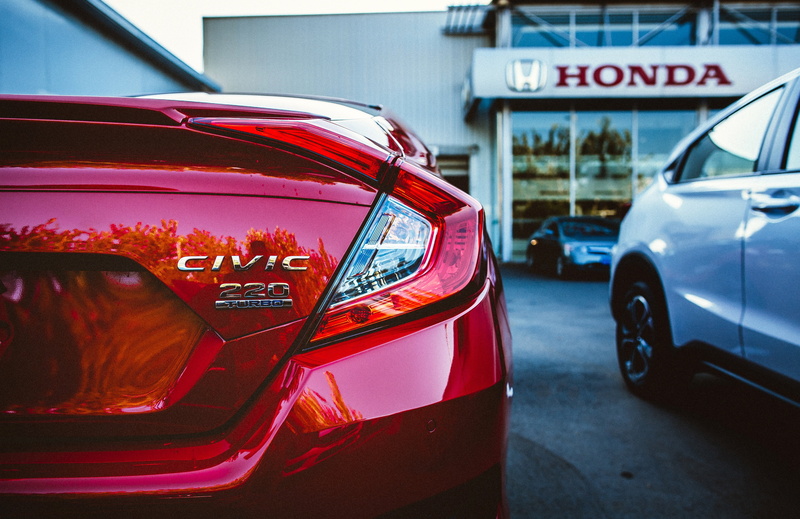 red, sports car, transportation, sign, traffic, honda civic, wheel, no people, road, architecture, outdoors, luxury, mode of transportation, focus on foreground