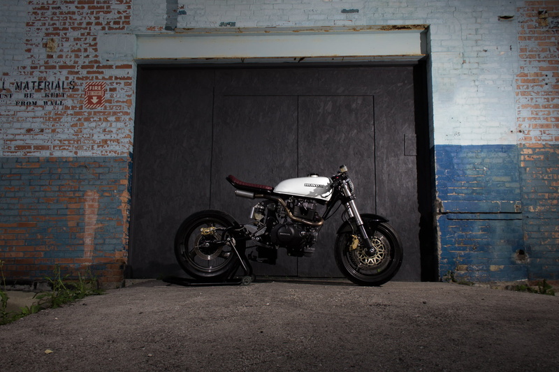 architecture, scooter, building exterior, cafe racer, transportation, wrenchmonkees, parking, wall - building feature, door, wheel, day, one person, entrance