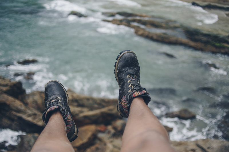 human leg, relaxation, skin, rock - object, hiking, rock, sneaker, personal perspective, boot, water, body part, human, adventure, footwear, boots, wearing