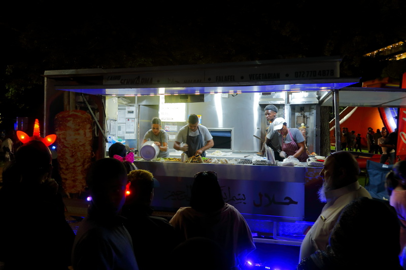 dish, lights, outdoors, lifestyles, real people, leisure activity, night, restaurant, large group of people, shorts, person, kiosk, group of people, indoors