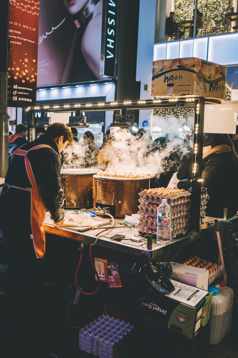 text, hair, market stall, person, apparel, communication, clothing, machine, business, for sale, shelf, myeong-dong, women, illuminated, human, people