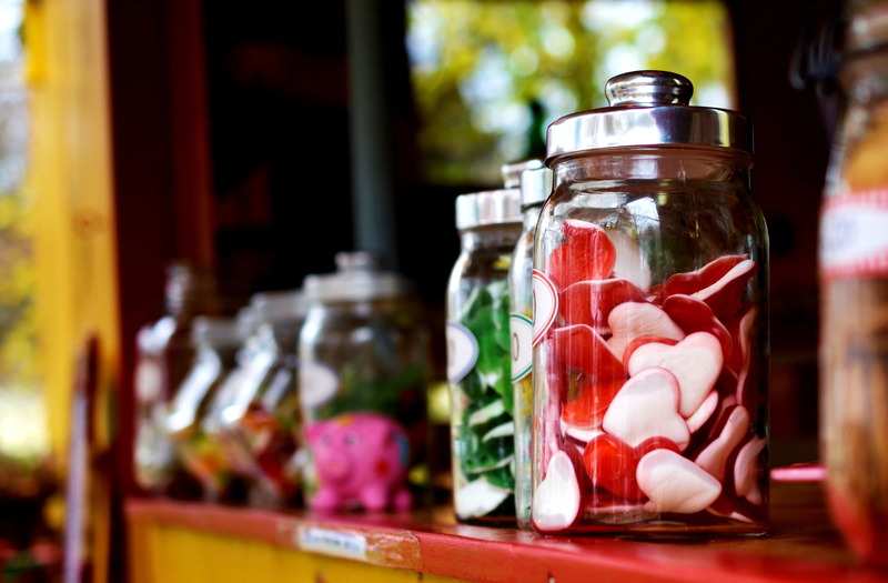 large group of objects, transparent, fruit jelly, food and drink, focus on foreground, preserves, jars, candy-glass, clear, sugar, store, container, table