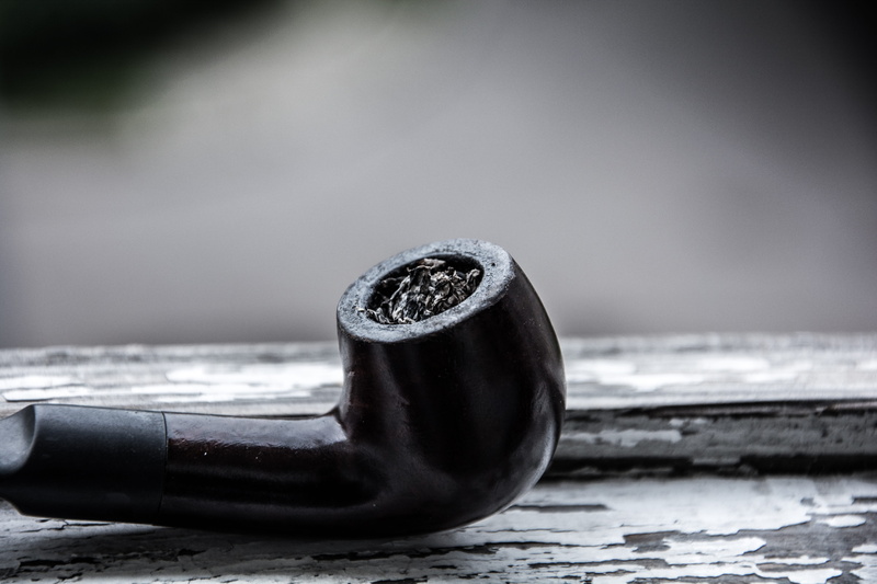 black color, alloy, simplicity, outdoors, metal, single object, pipe, close-up, still life, equipment, social issues, noir, urban, strength, tobacco, day