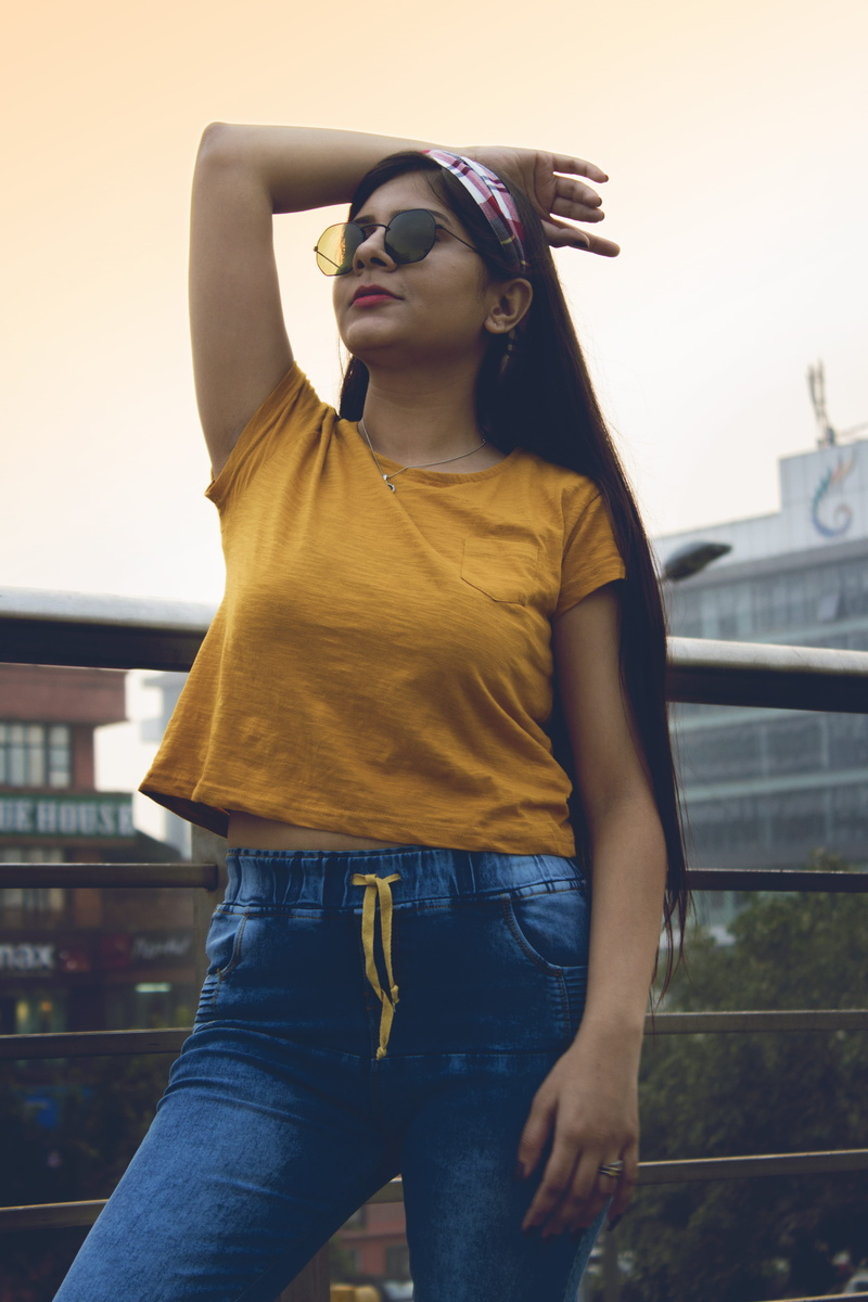 focus on foreground, standing, fashion, accessories, glasses, accessory, wearing, young adult, t, front view, young women, pants, sunglasses, built structure