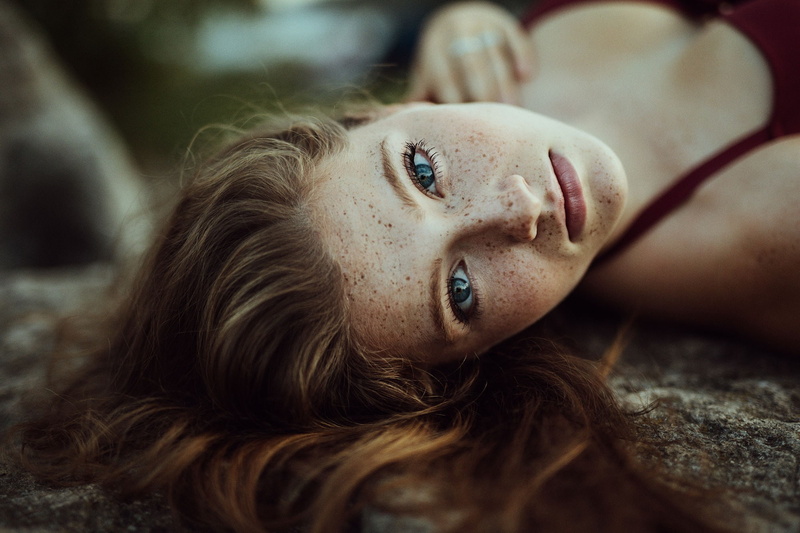 teenager, hair, headshot, looking at camera, portrait, brunette, lying down, body part, blue eyes, brown hair, lying on back, beautiful woman, human face