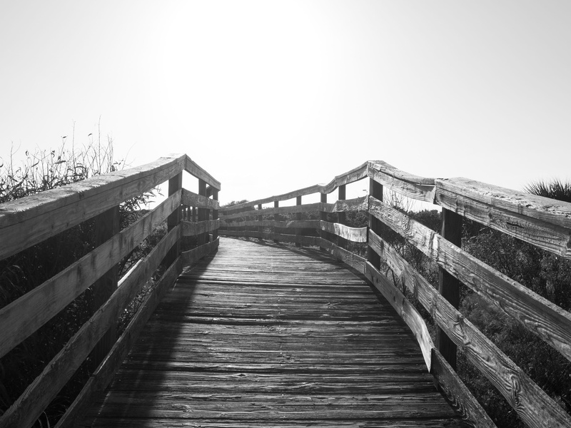 walkway, sunset, clear sky, railing, direction, wood, black and white, high key, tranquility, beach, wood - material, architecture, bridge - man made structure