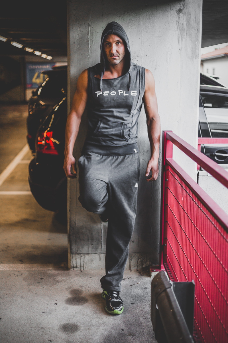 cats, holding, lifestyles, wearing, full length, concrete, indoors, hooded, men, lights, architecture, young women, black, man, standing, urban, pose, young men