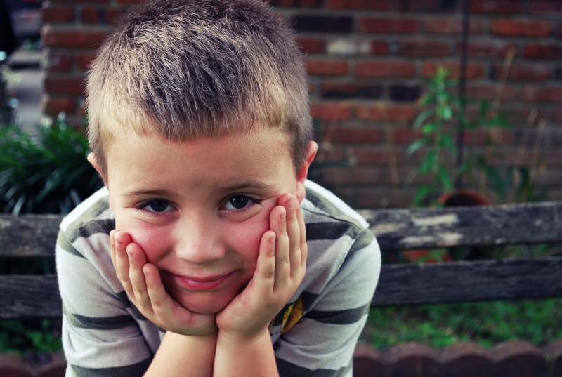 waiting, sad eyes, real people, smiling, front view, hand, cute, white, young man, child, headshot, looking at camera, human body part, males, lifestyles