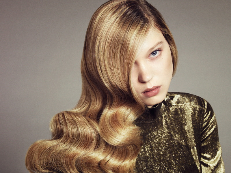 front view, blue eyes, gray background, looking at viewer, actress, young adult, hair over one eye, Léa Seydoux, wavy hair, hairstyle, blonde, beautiful woman
