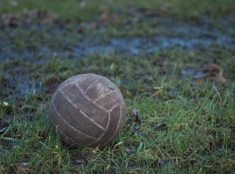 competition, outdoors, focus on foreground, sports equipment, dirty, close-up, old, 2K, land, nature, team sport, grass, game over, worn, green color