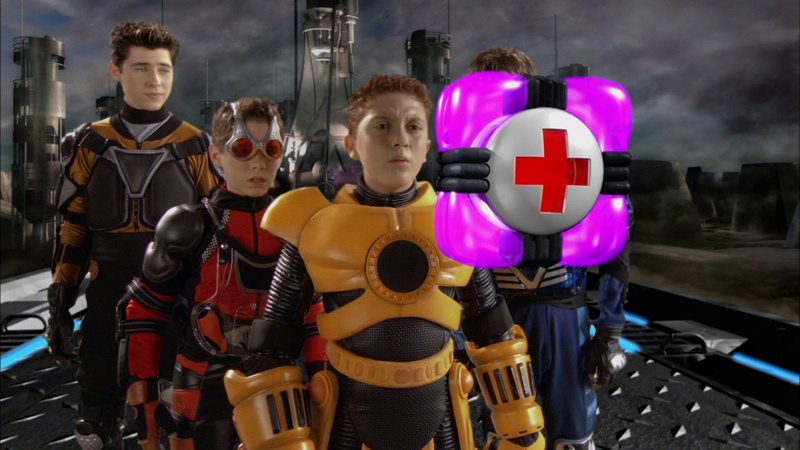 toy, child, standing, spy kids 3 d game over, women, people, males, indoors, girls, group of people, childhood, waist up, boys, offspring, holding, human representation