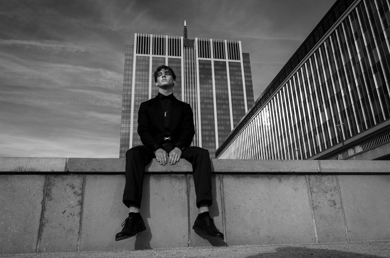 grayscale, unsplash, sitting, wall, looking at camera, architecture, night, male, young women, casual clothing, full length, 4K, built structure, real people