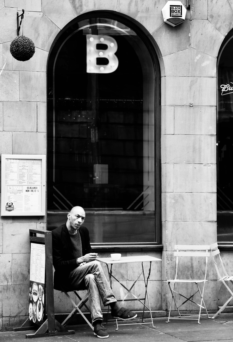 day, building, chair, window, beside, lifestyles, waiting, chairs, real people, bald, seat, built structure, building exterior, male, daylight, city, full length