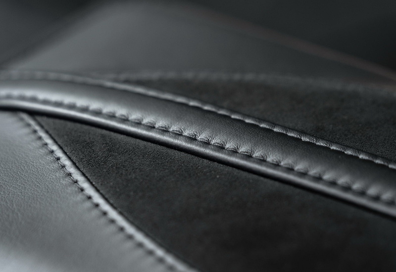 black background, high angle view, close-up, leather, grey, zipper, simplicity, aston, indoors, photography themes, arts culture and entertainment, no people