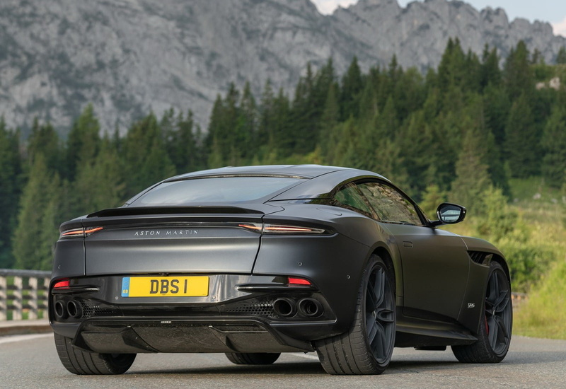 transportation, text, grey, no people, road, sign, motor vehicle, day, plant, superleggera, luxury, travel, car, tree, land vehicle, dbs, xenon, sports car