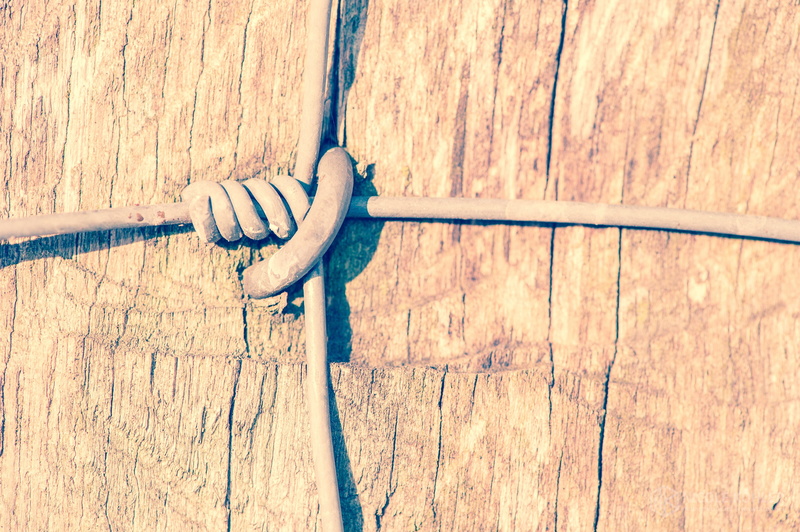 tied up, metal, day, top, wire, wooden, no people, connection, full frame, wall - building feature, protection, tied, cable, safety, security, close-up