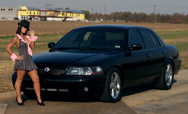 real people, using phone, young women, land vehicle, one person, mobile phone, full length, girls and cars, standing, young adult, transportation, side view