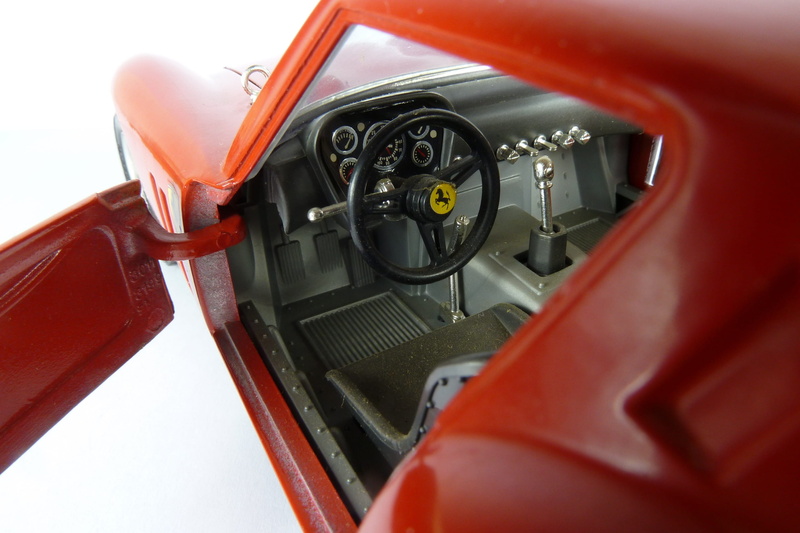 model car, motor vehicle, airplane, dashboard, ferrari, close-up, technology, air vehicle, red, steering wheel, gto, cockpit, selective focus, wheel, equipment