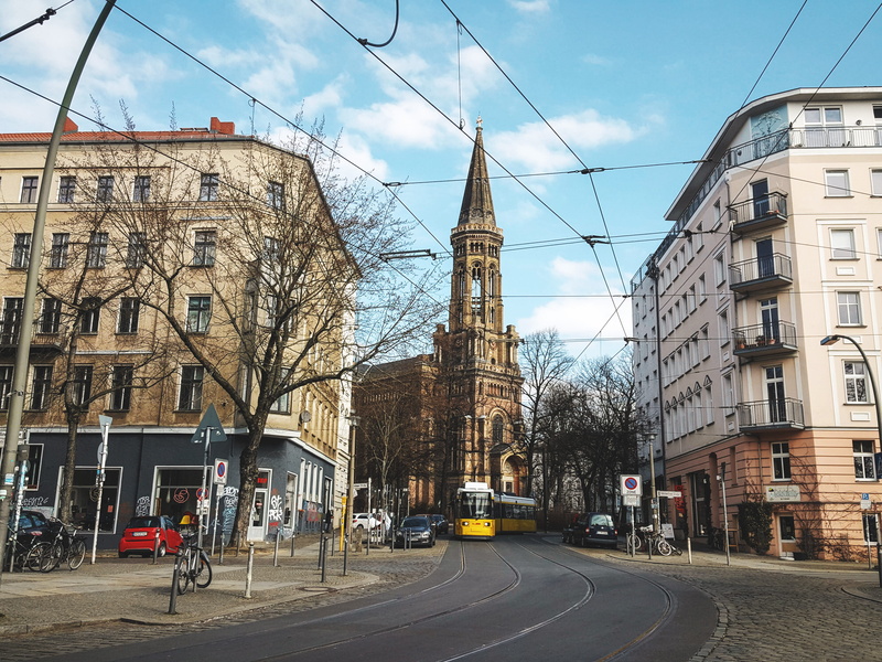 church, berlin, tramway, blue sky, sign, europe, residential district, yellow, land vehicle, architecture, bare tree, germany, city, tram, road, old city