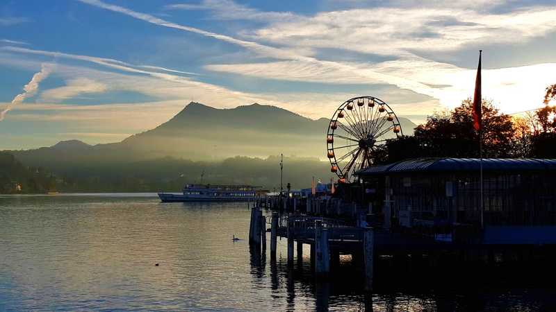 ferris wheel, pier, amusement park ride, sky, sunset, architecture, lake lucerne, water, peaceful, mountain, built structure, beauty in nature, no people