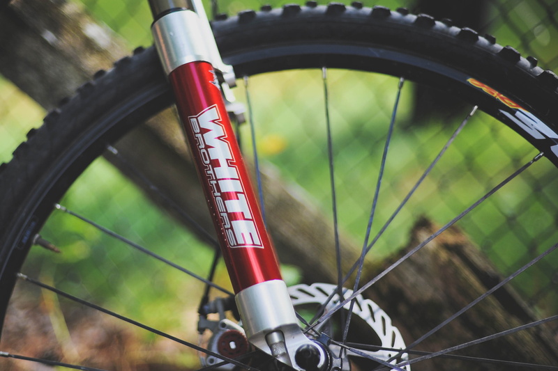text, communication, mode of transportation, wheel, bicycle, grey, brothers, white, equipment, land vehicle, day, no people, red, telescopic, 2K, mountain bike