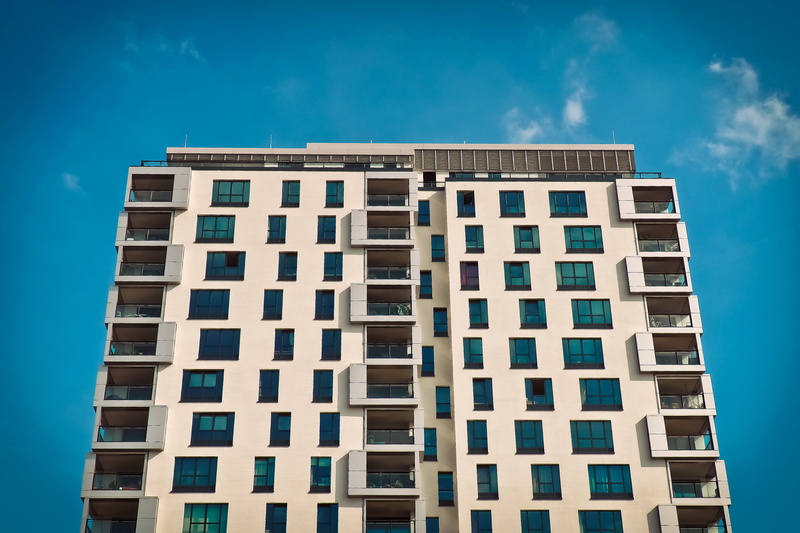 no people, building exterior, skyscraper, balcony railing, urban, apartment, live, built structure, blue, white, day, tall - high, downtown, railing, modern
