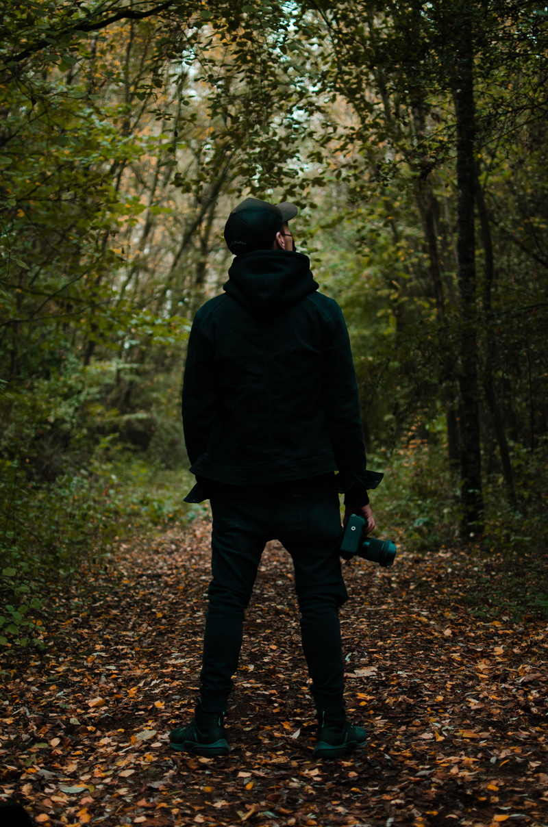 leisure activity, lifestyles, walking, real people, woodland, person, autumn, camera, full length, sweater, top, nature, rear view, nike, leaf, change