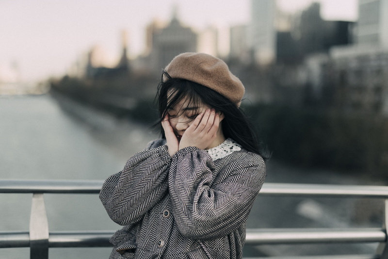 sweater, hair, hood, young adult, focus, top, selective, cap, beanie, banister, hairstyle, bonnet, building exterior, photo, focus on foreground, front view