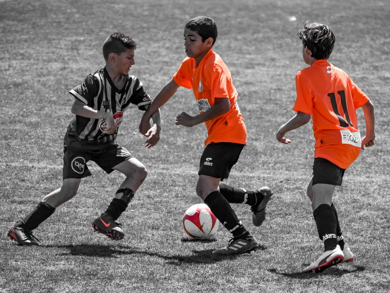 motion, teamwork, men, sport, outdoors, child, clothing, togetherness, people, full length, day, sports equipment, player, males, action energy, playing