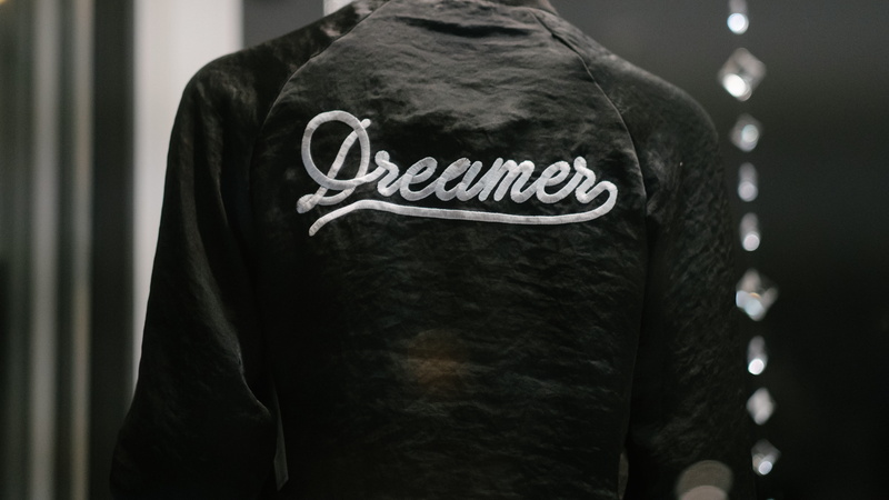 printed, dreamer, emotion, dark, person, western script, jacket, obscured face, type, headshot, one person, midsection, rear view, portrait, real people