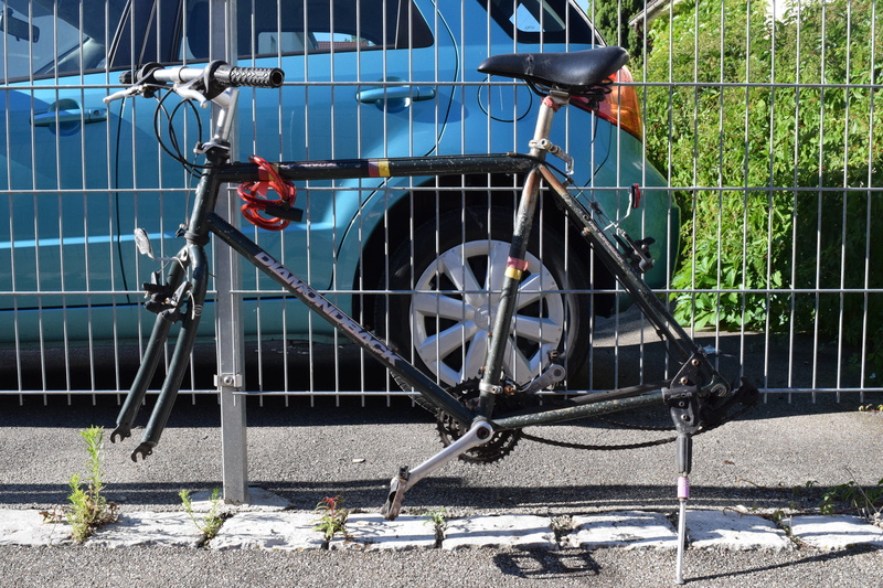 stationary, mode of transportation, mature away, day, bike, built structure, no people, bicycle, barrier, stolen, outdoors, no mature, boundary, metal