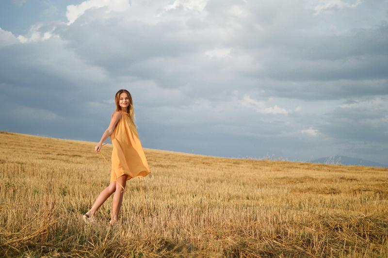 freedom, woman, outdoor, environment, beautiful woman, long hair, mountain, emotion, day, smiling, wearing, young adult, outdoors, yellow, hair, cloud - sky
