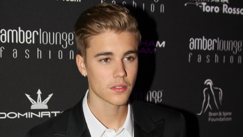 text, males, headshot, adult, indoors, front view, young adult, business person, justin bieber  images, black background, contemplation, business, blackboard