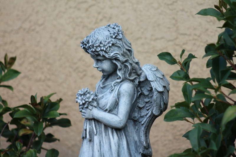 art and craft, plant part, wall - building feature, decoration, human representation, statuette, spirituality, growth, carving, religious sculpture, female likeness
