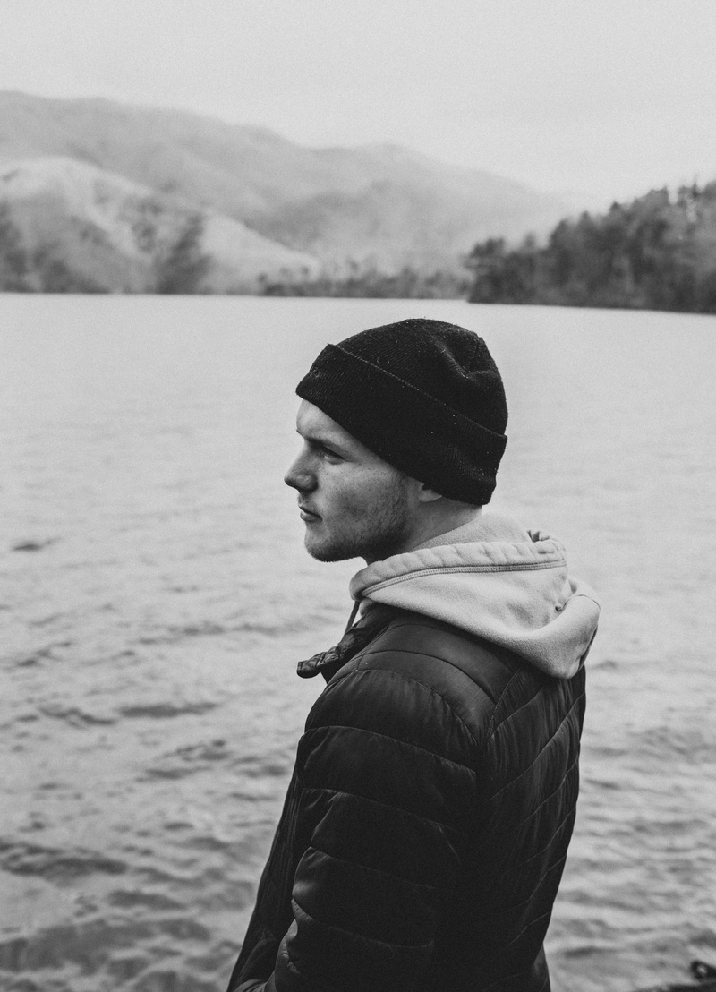 lake, men, man, cap, apparel, beanie, sea, body, one person, nature, hat, model, day, explore to create, human, grey, contemplation, leisure activity, focus on foreground