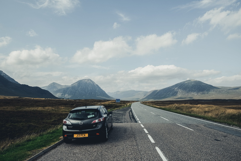 dividing line, road trip, symbol, direction, road marking, cloud - sky, mountain range, transportation, mode of transportation, marking, wanderlust, car