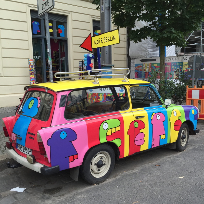 building exterior, colorful, sign, art, built structure, car, street, mode of transportation, communication, no people, day, pait, berlin, city, red, architecture