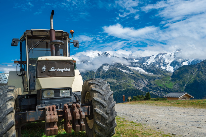text, summer, sky, working machine, machine, mountains, formation, tractor, tranquil scene, 5K, outdoors, communication, snowcapped mountain, agricultural machine